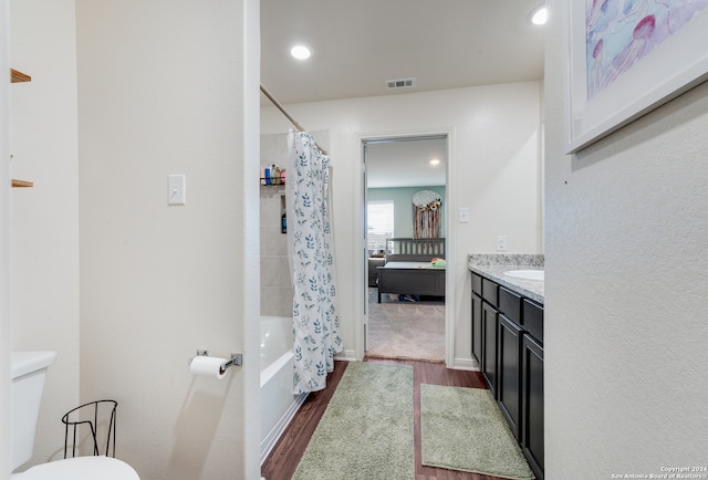 full bathroom featuring vanity, toilet, shower / tub combo, and wood-type flooring