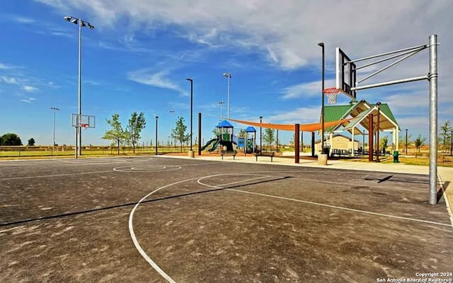 view of sport court with a playground