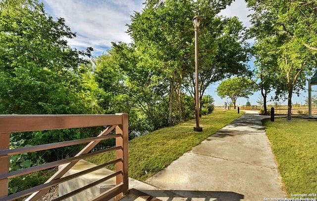 view of gate featuring a yard