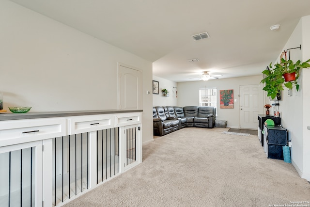 living room featuring ceiling fan and light carpet