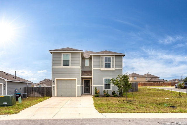 view of front facade with a garage, a front yard, and central AC