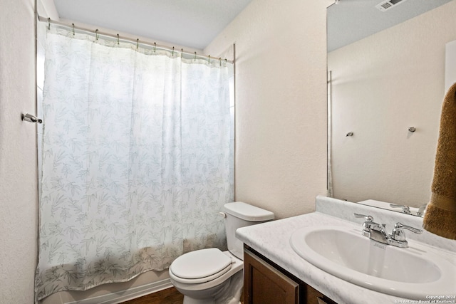 full bathroom featuring vanity, toilet, hardwood / wood-style flooring, and shower / bath combination with curtain