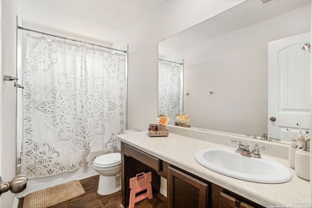 full bathroom featuring vanity, toilet, shower / tub combo with curtain, and wood-type flooring