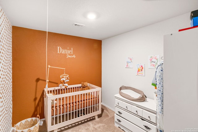 carpeted bedroom featuring a crib