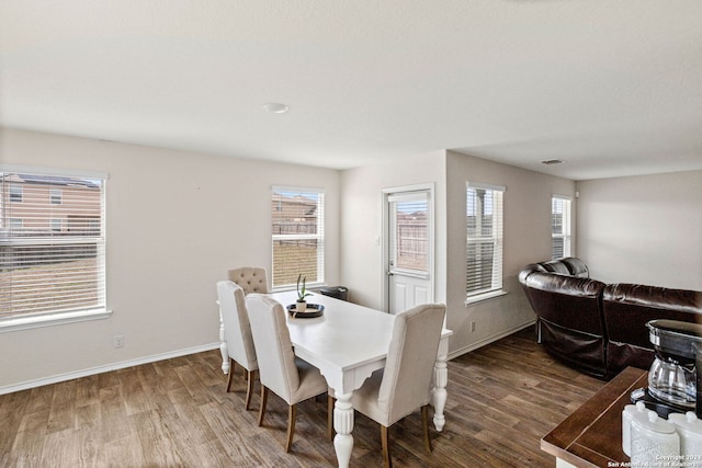 dining space with dark wood-type flooring