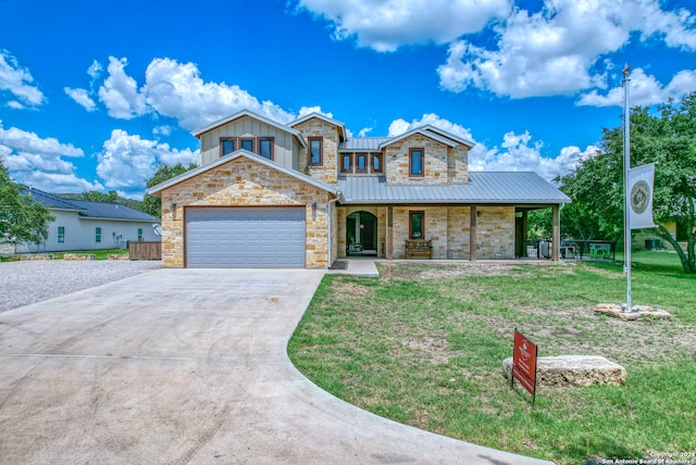 view of front of property with a garage, a porch, and a front lawn