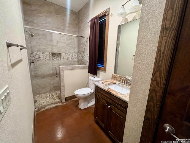 bathroom with vanity, concrete floors, a shower with shower door, and toilet