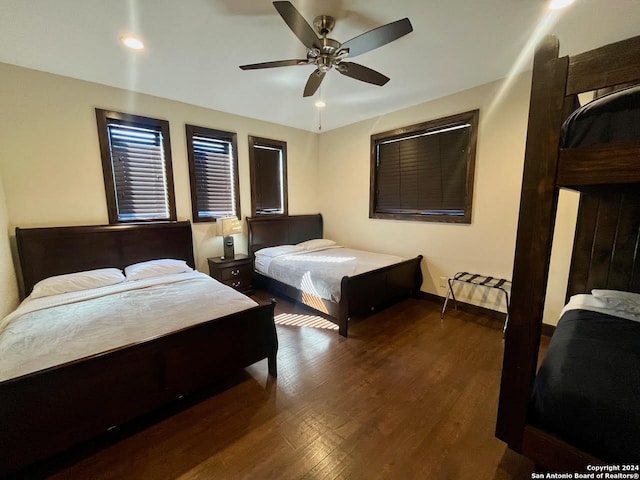 bedroom with ceiling fan and dark hardwood / wood-style floors