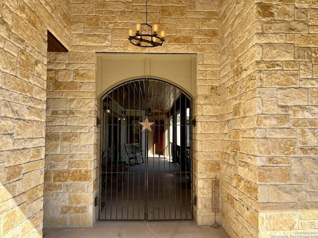 236 Tequila Sunrise, Concan, TX 78838 - view of exterior entry featuring stone siding, a gate, and brick siding