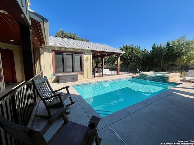 view of pool featuring an in ground hot tub and a patio area