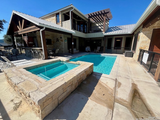 view of pool with an in ground hot tub and a patio area