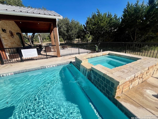 view of pool featuring an in ground hot tub