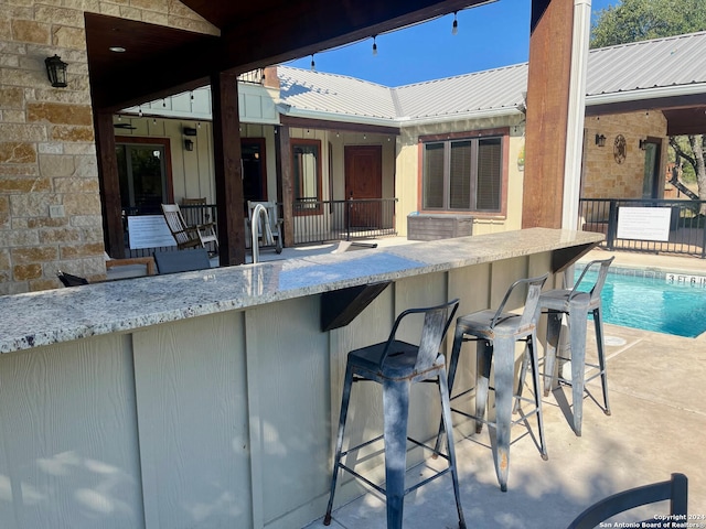 view of patio / terrace featuring exterior bar