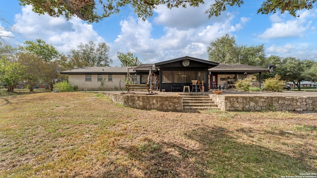 rear view of house with a yard