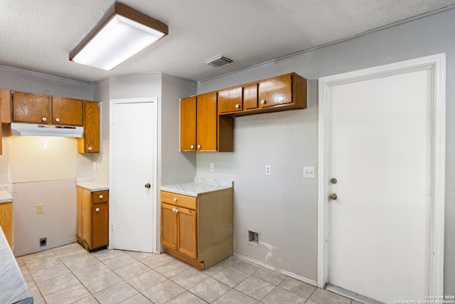 kitchen featuring light tile patterned floors and a textured ceiling