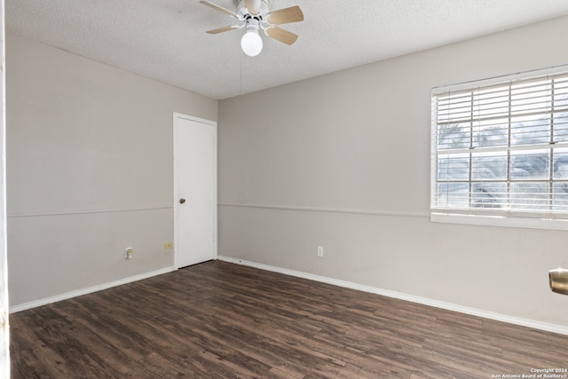 unfurnished room with ceiling fan, dark hardwood / wood-style flooring, and a textured ceiling