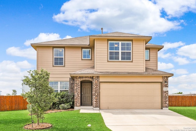 traditional home with a front lawn, concrete driveway, fence, and brick siding