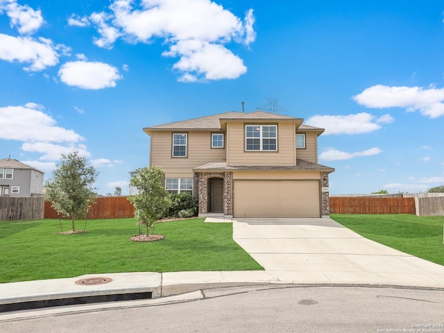 view of front of home with driveway, an attached garage, a front yard, and fence