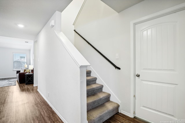 stairway featuring wood-type flooring