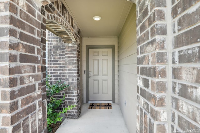 entrance to property with brick siding