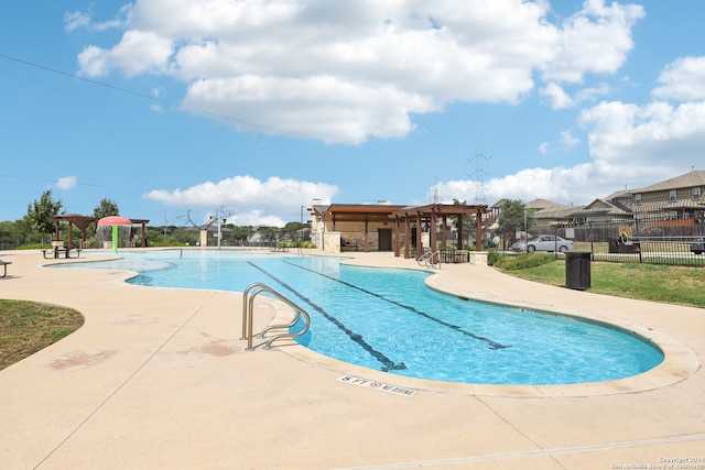 view of swimming pool featuring a patio area and a pergola