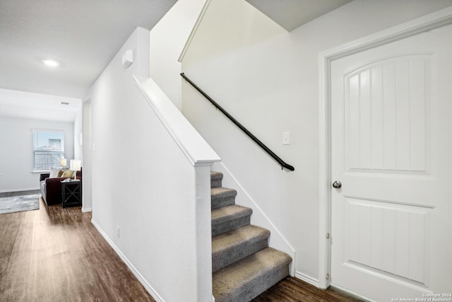 stairway featuring baseboards and wood finished floors