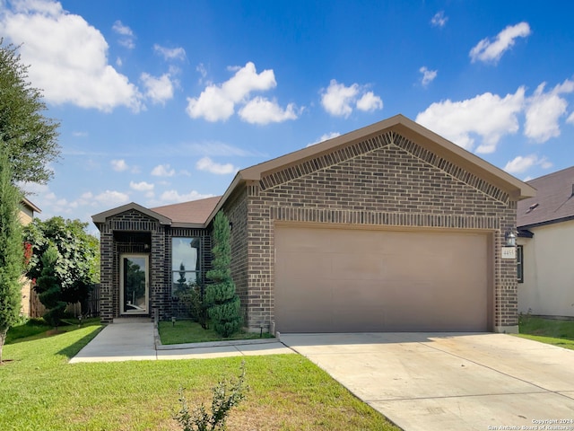 view of front of property featuring a garage and a front lawn