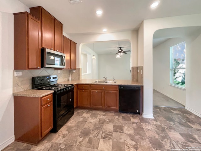 kitchen with pendant lighting, tasteful backsplash, black appliances, sink, and ceiling fan