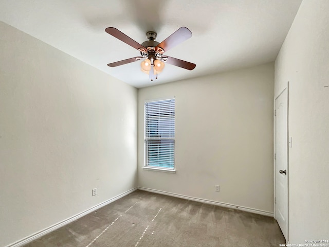 spare room with carpet and ceiling fan