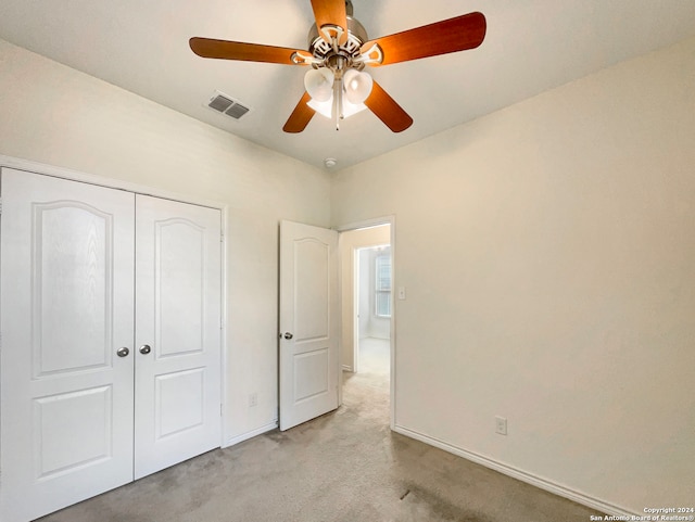 unfurnished bedroom featuring carpet flooring, a closet, and ceiling fan