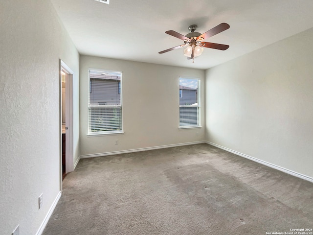 unfurnished room featuring carpet flooring, ceiling fan, and plenty of natural light