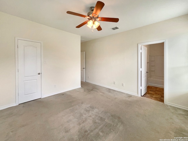 unfurnished bedroom featuring connected bathroom, ceiling fan, and carpet