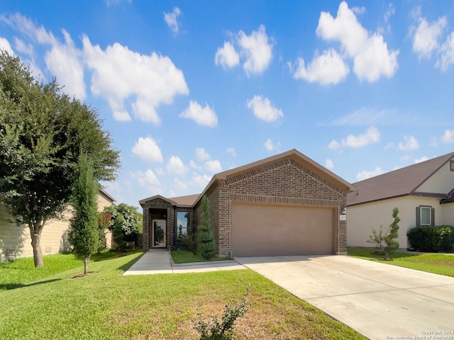 view of front of property featuring a garage and a front yard