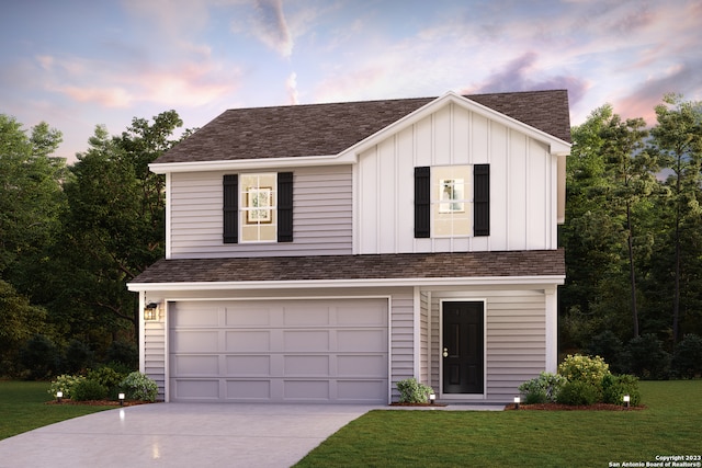 view of front of house featuring a lawn and a garage