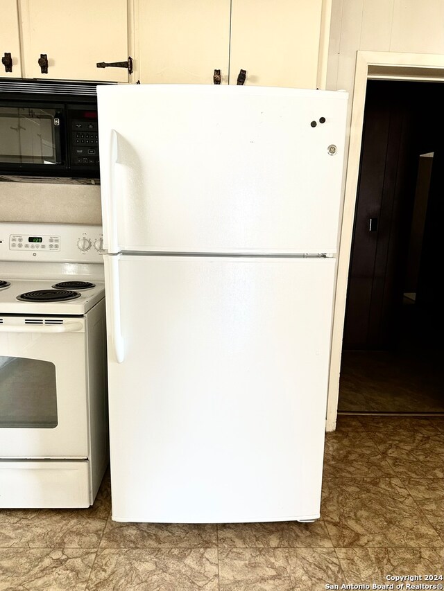 kitchen with white appliances and white cabinetry