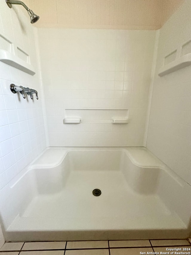 bathroom with a shower and tile patterned floors