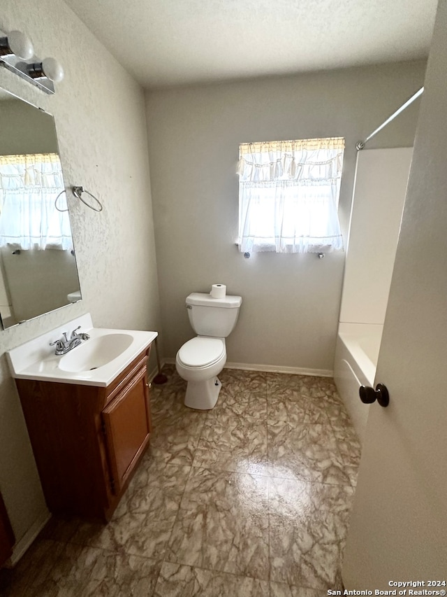 full bathroom featuring a textured ceiling, vanity, toilet, and shower / bath combination