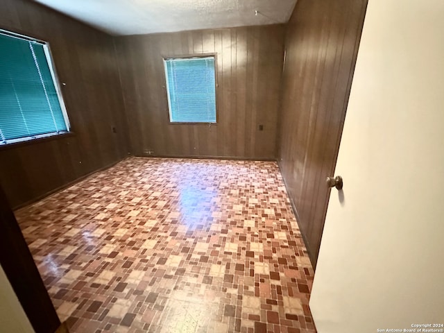 empty room featuring wooden walls