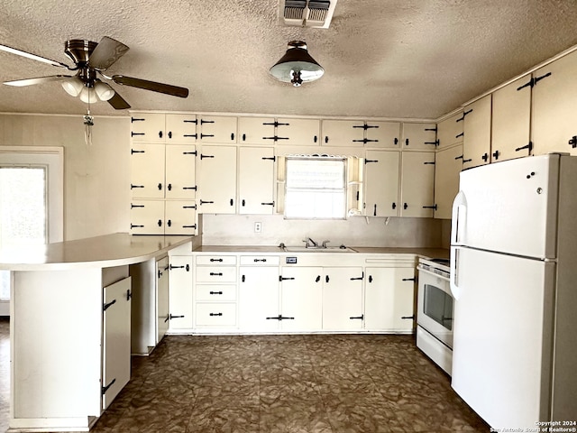 kitchen featuring white appliances, a textured ceiling, kitchen peninsula, ceiling fan, and white cabinets