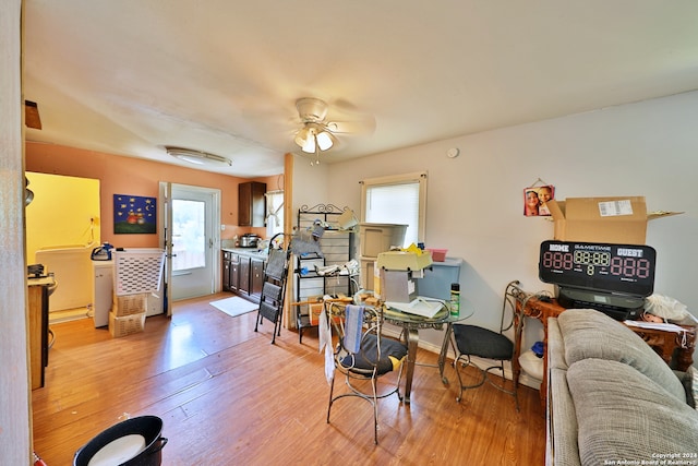 living area with ceiling fan and light wood-type flooring