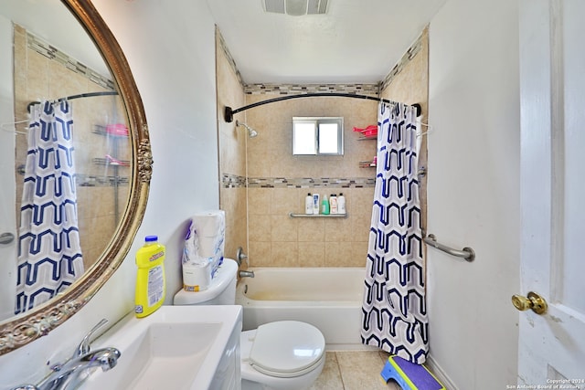 bathroom featuring tile patterned floors, visible vents, shower / bath combo with shower curtain, toilet, and a sink