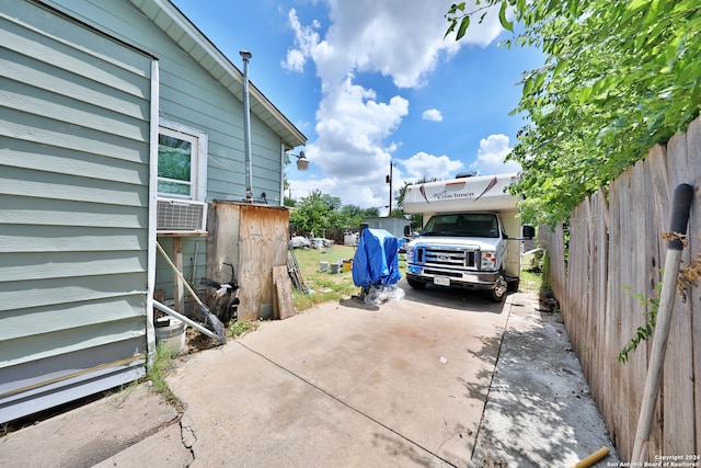 exterior space with concrete driveway and fence