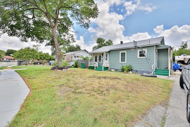 exterior space with a front yard and covered porch