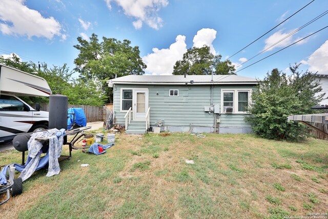 rear view of property with a yard