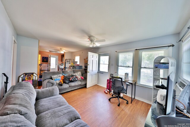 living room featuring ceiling fan and light hardwood / wood-style floors