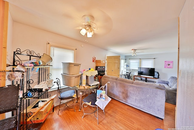 living room featuring hardwood / wood-style floors and ceiling fan