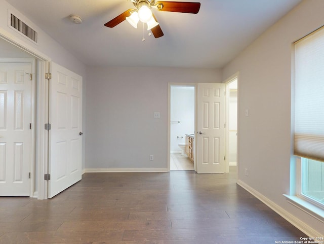 spare room with dark wood-type flooring and ceiling fan