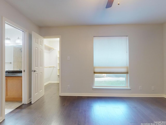 spare room featuring ceiling fan and dark hardwood / wood-style flooring