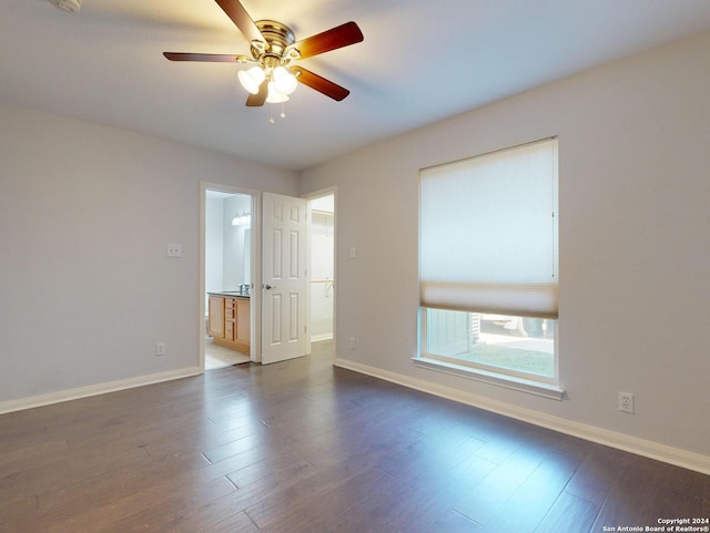 spare room with ceiling fan and dark hardwood / wood-style floors