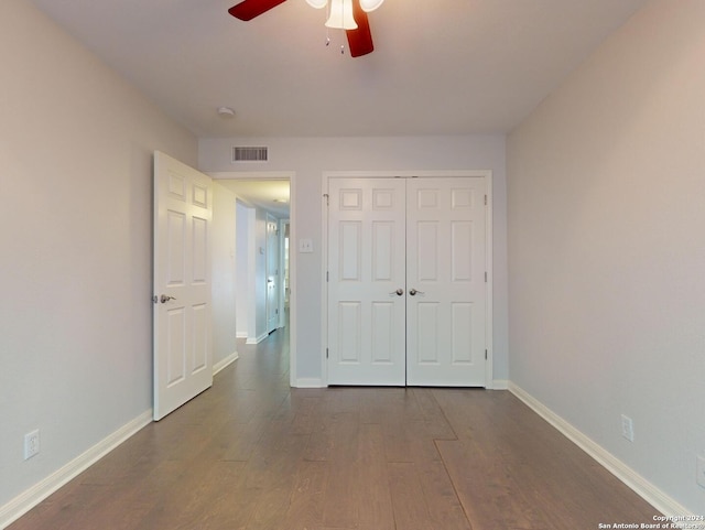 unfurnished bedroom with a closet, ceiling fan, and hardwood / wood-style floors